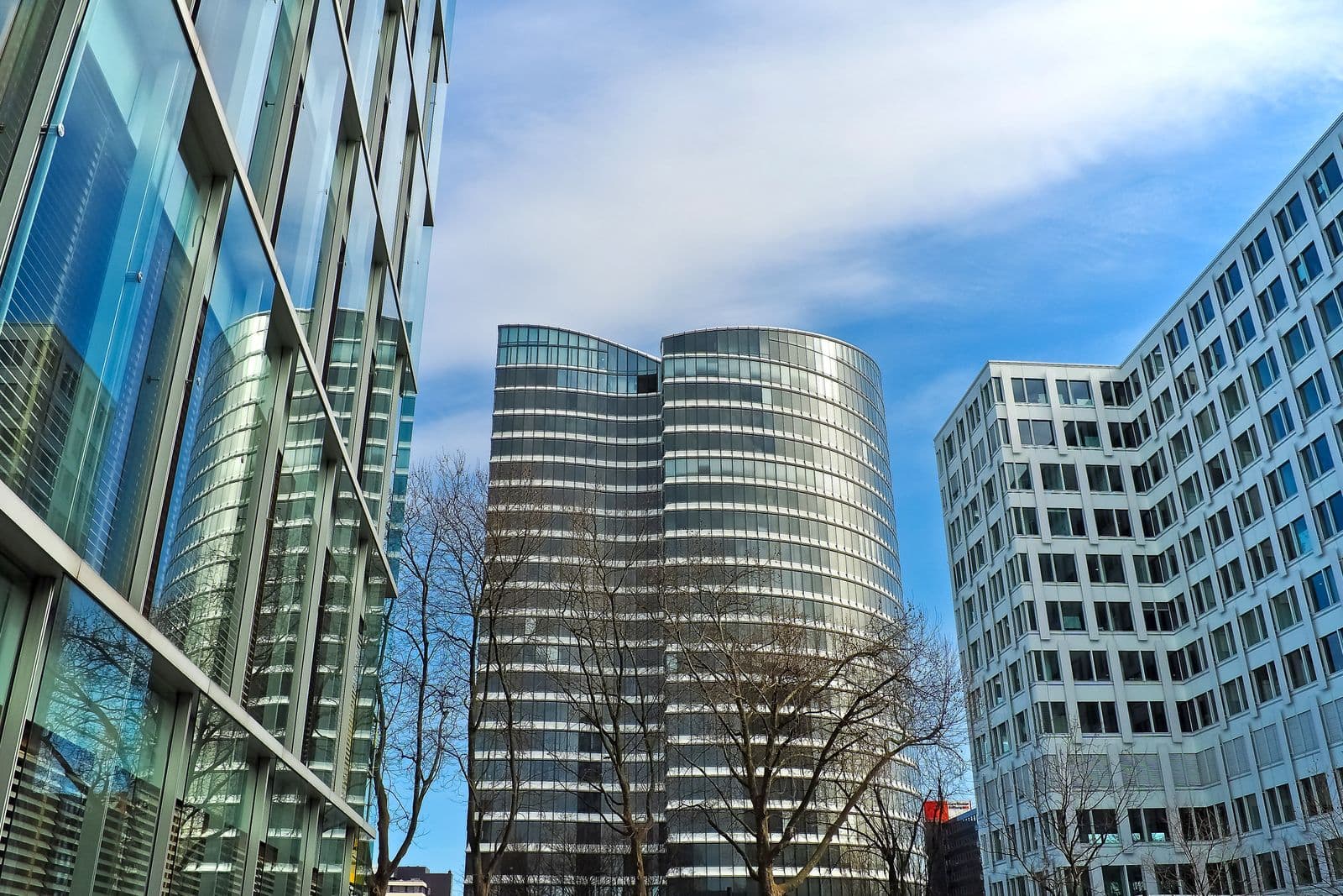 Cluster of modern corporate glass towers representing the regulatory institutions we answer to